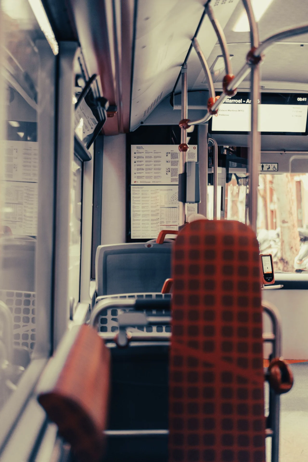 Real public bus interior with seating and overhead fittings, shown as a setting example