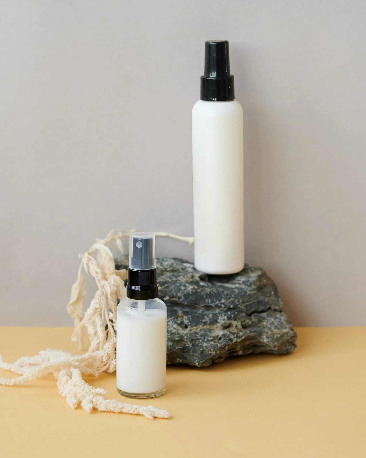 Real photograph of plain fine mist bottles illustrating hair mist packaging