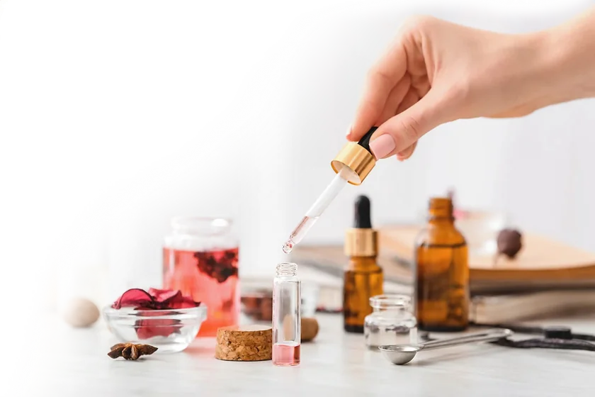 Fragrance oils being prepared with a pipette and sample bottles